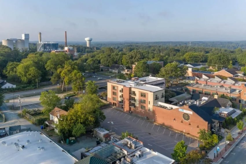 Apartment building with balconies and parking exterior at Courtyard Lofts in Chapel Hill Student Accommodation