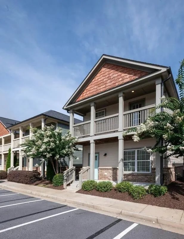 Townhouses with balconies and flowering trees exterior at The Collective at Kennesaw in Kennesaw Student Accommodation