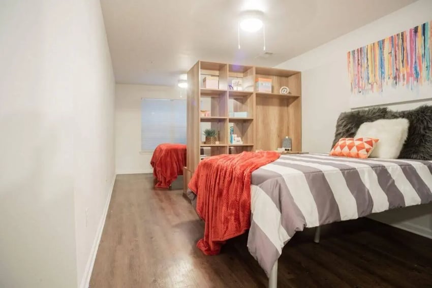 Two beds bookshelf colorful art bedroom at Sparq On Rio in Austin Student Accommodation