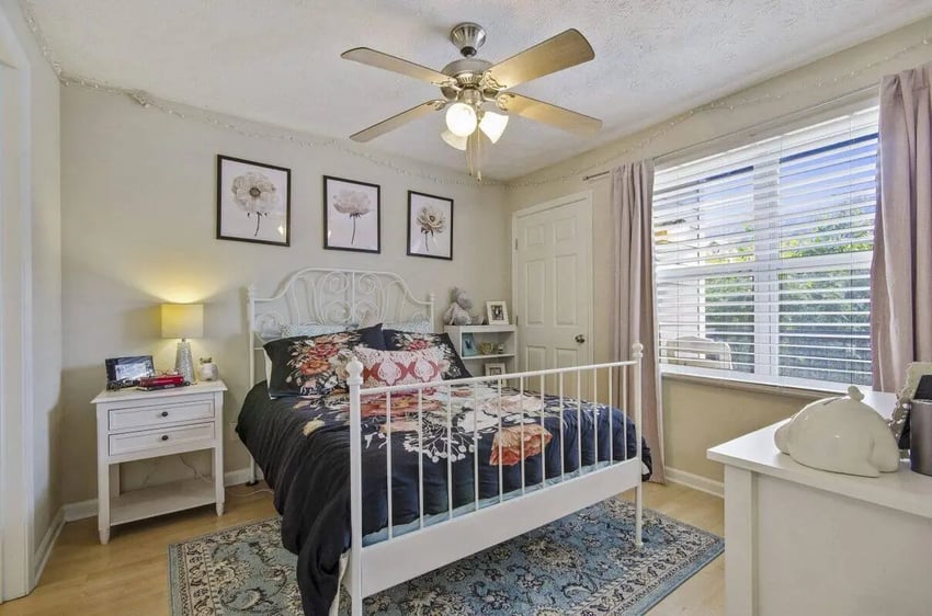 White metal bed floral bedding nightstand bedroom at Logan Square in Auburn Student Accommodation