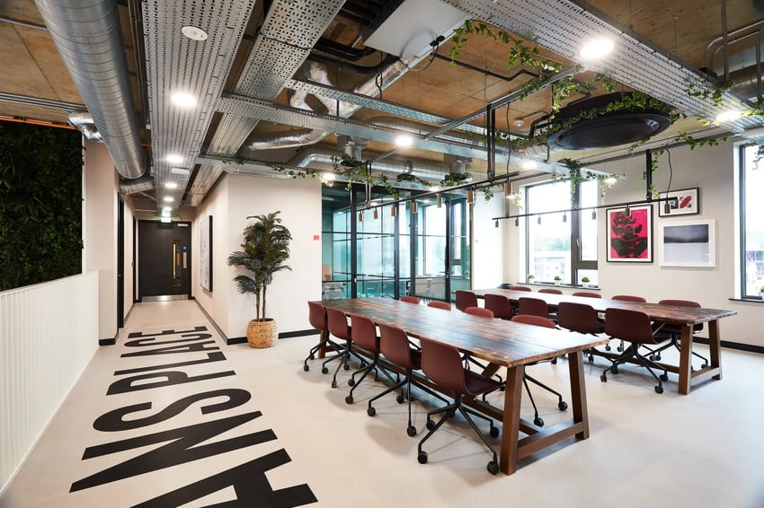 Communal tables with chairs and artwork Living room at Vita Student St.Albans in Leeds Student Accommodation