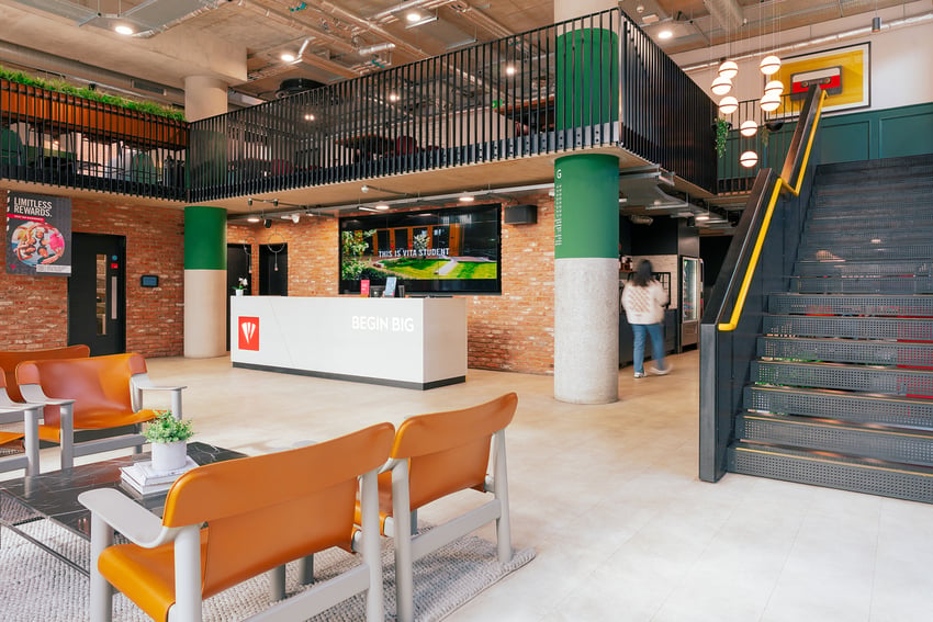 Reception area with modern furniture and stairs at Vita Student Station Street in Nottingham Student Accommodation