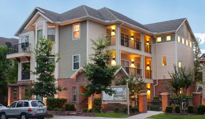 Apartment building with balconies and trees exterior at Ashton Lane Luxury Apartments in Gainesville Student Accommodation