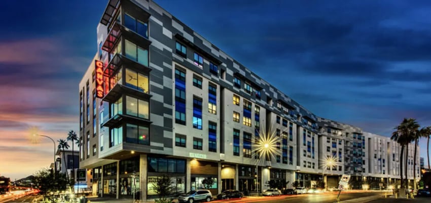 Modern building with neon sign exterior at Canvas in Tempe Student Accommodation