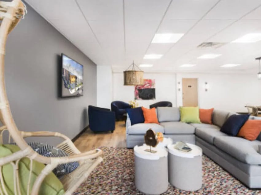 Lounge with sectional sofa hanging chair living room at UCity Flats in Philadelphia Student Accommodation