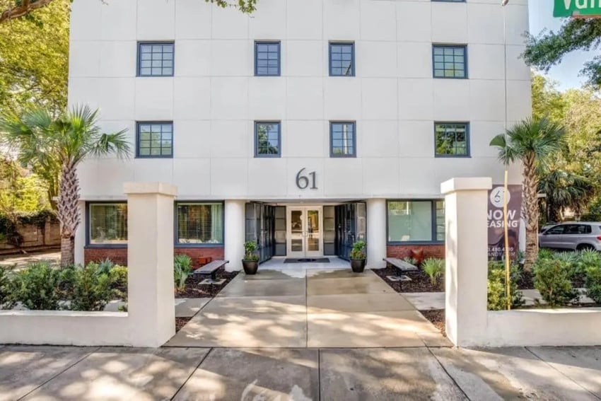 Building entrance with benches and palm trees exterior at 61 Vandy in Charleston Student Accommodation