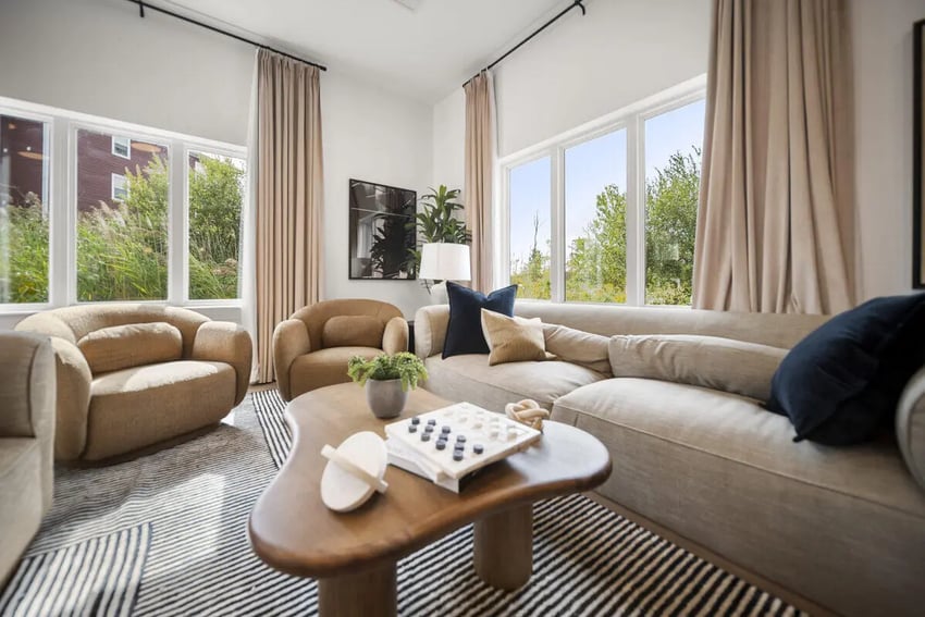 Modern living room with neutral sofa and chairs at Block20