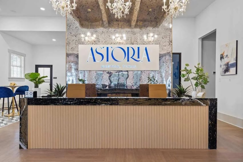 Reception desk plants and Astoria logo lobby at Astoria in Denton Student Accommodation