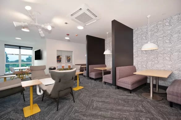 Seating areas with tables and chairs living room at ANOVA Aggie Square in Sacramento Student Accommodation