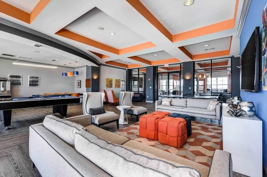 Billiard table sofas chairs and ottomans lounge area at High View in San Antonio Student Accommodation
