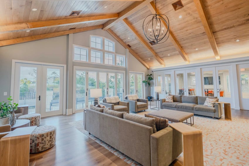 Modern living room with sofas tables and large windows living room at Maple Ridge Townhomes in Blacksburg Student Accommodation