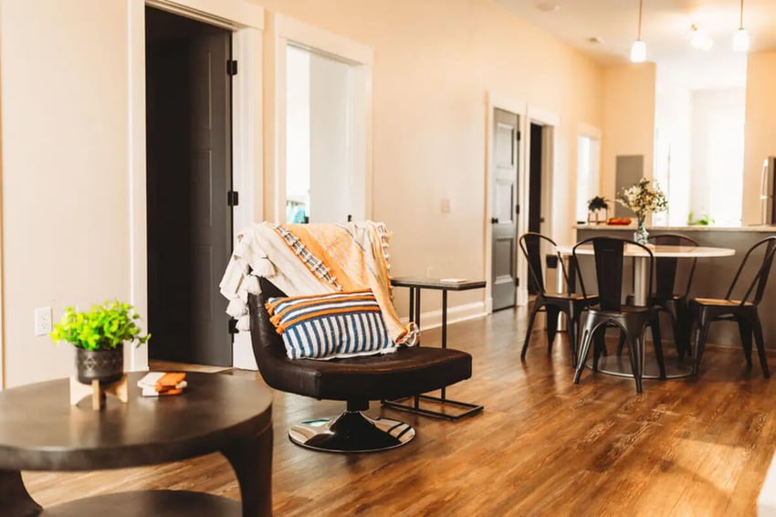 Armchair dining table and chairs living room at College Corners on High in Farmville Student Accommodation