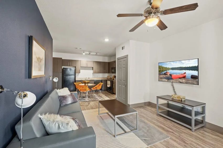 Sofa coffee table kitchen and dining area living room at Holleman Crossing in College Station Student Accommodation