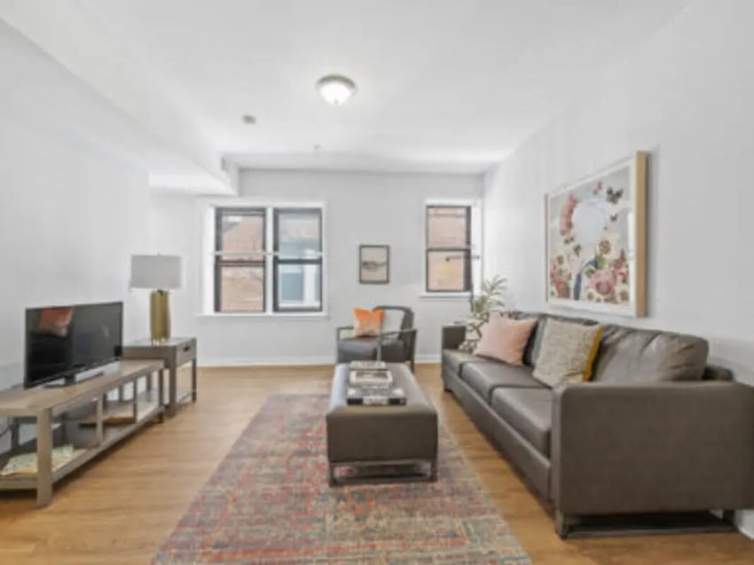 Sofa coffee table and TV living room at The Legacy at Powelton Village in Philadelphia Student Accommodation
