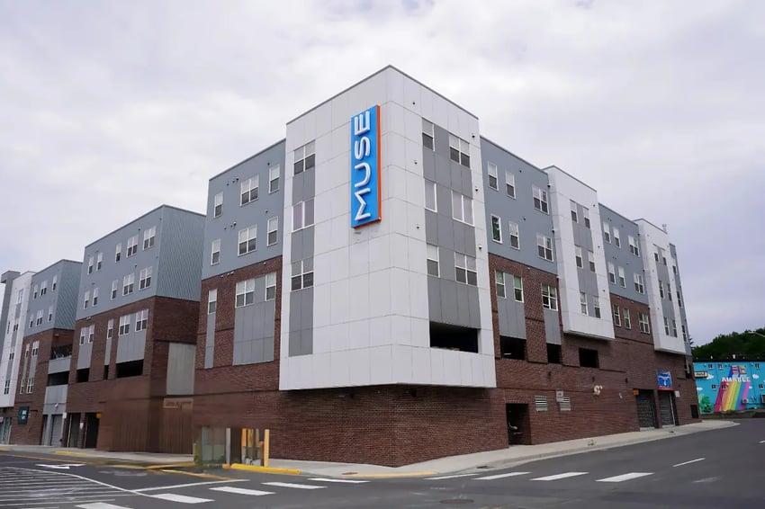 Modern apartment building exterior with Muse signage exterior at Muse on Main in Pullman Student Accommodation
