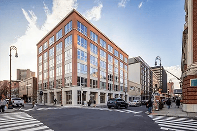 Modern brick building on a street exterior at The Archive in New Haven Student Accommodation