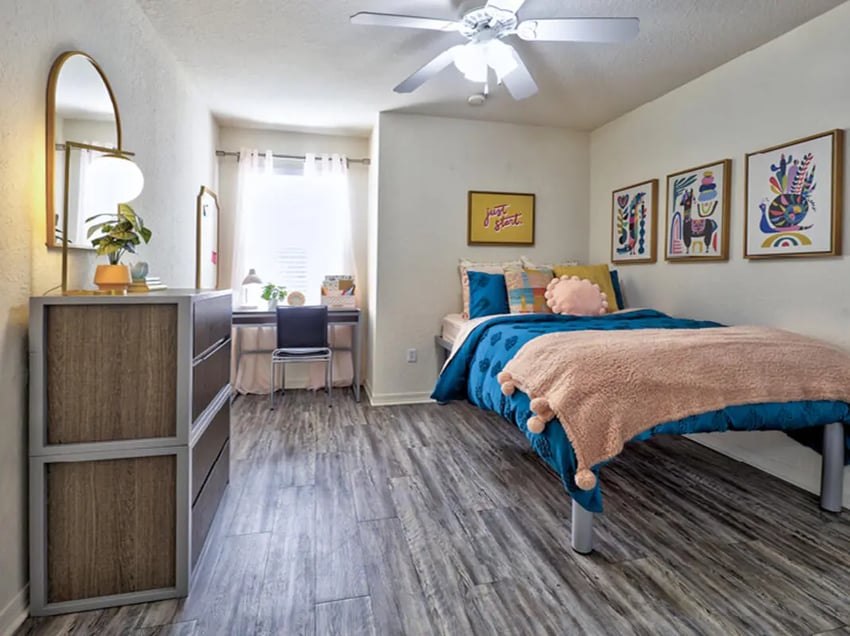 Bed dresser desk and artwork bedroom at Mercury 3100 in Orlando Student Accommodation