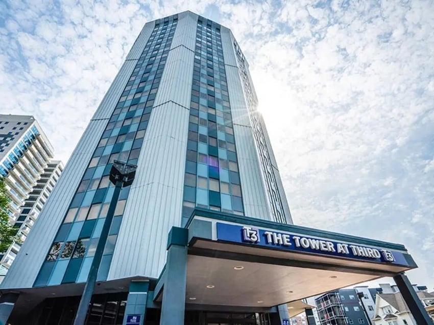 Tall building with windows and entrance exterior at The Tower at Third in Champaign Student Accommodation