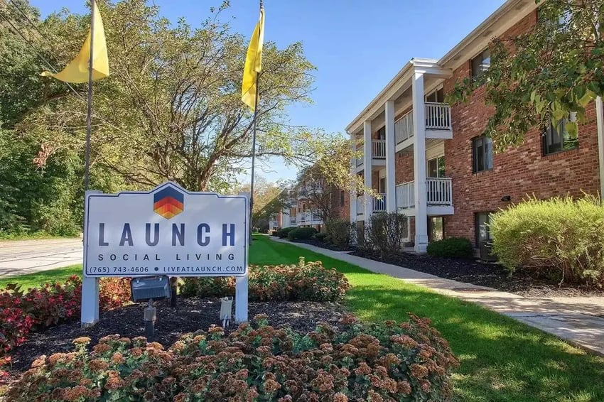 Launch sign and apartment buildings exterior at Launch Apartments in West Lafayette Student Accommodation