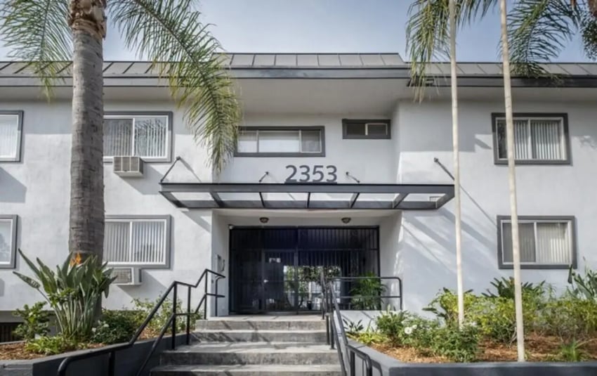 Apartment building exterior with palm trees exterior at USC Student Housing: Heritage 2353 in Los Angeles Student Accommodation
