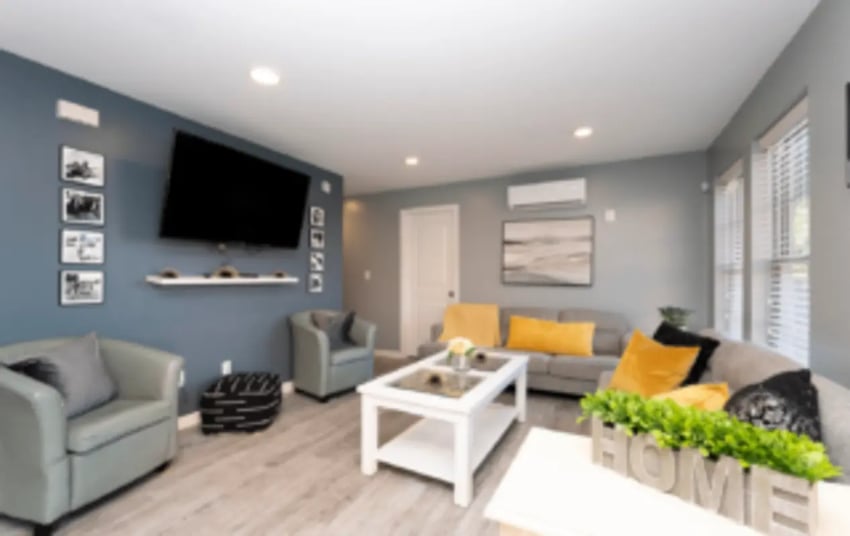 Gray chairs white coffee table sofa living room at Victory Villages in Winston-Salem Student Accommodation