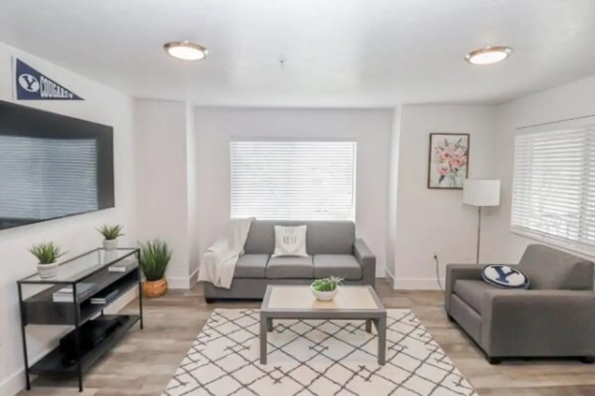Gray couches coffee table television living room at Fleur De Lis Apartments in Provo Student Accommodation