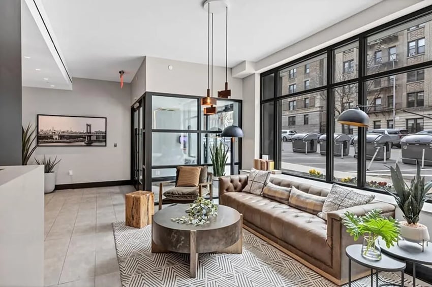 Brown sofa, coffee table, chair, living room at Monarch Heights Apartments