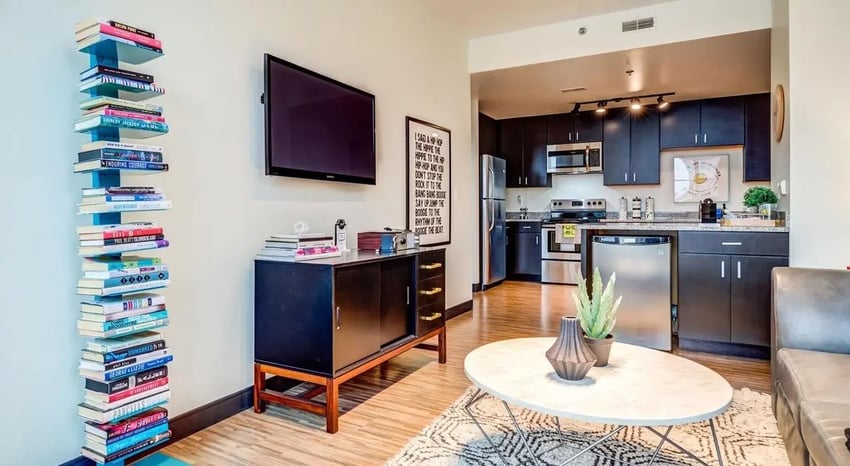 Bookshelf television cabinet and kitchen living area at Landmark Apartments in Ann Arbor Student Accommodation