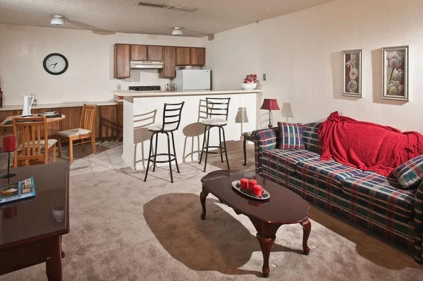 Sofa dining table kitchen counter living room at Baylor Plaza III in Waco Student Accommodation