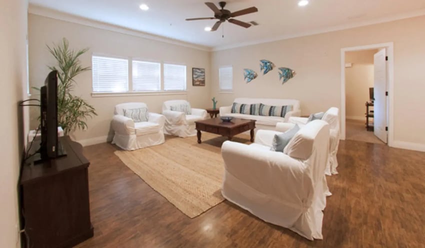 White couches coffee table TV plant living room at Archstone Luxury Apartments in Gainesville Student Accommodation