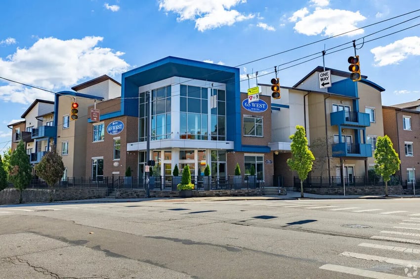 Modern student housing building with blue accents exterior at 65 West in Cincinnati Student Accommodation