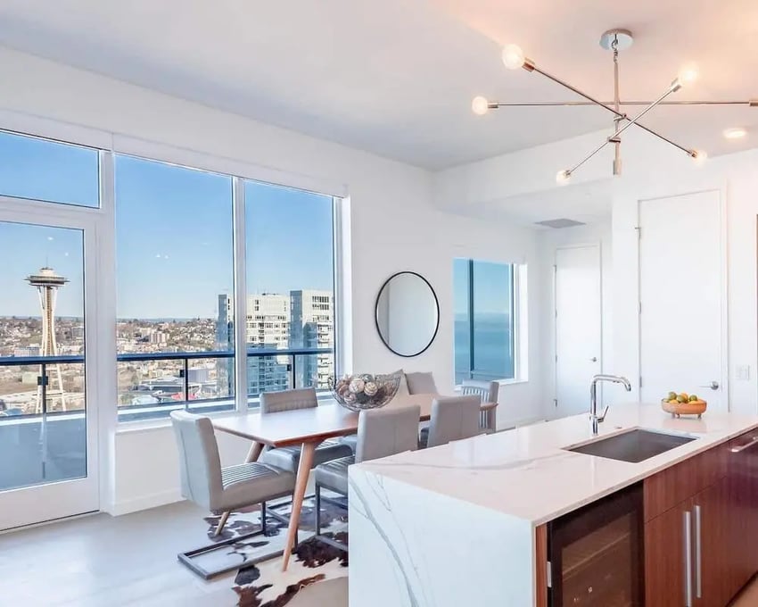 Dining table, chairs, kitchen island, city view. Dining room and kitchen. at Blanton Turner in Seattle Student Accommodation