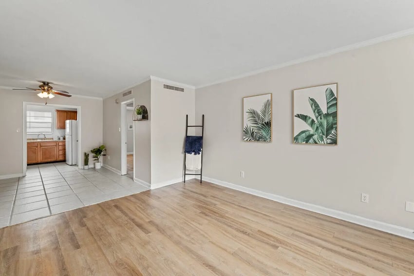 Living room with kitchen view and plant art Living room at Villa Capri Apartments in Tallahassee Student Accommodation