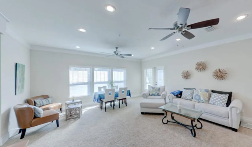 Sofa dining table chairs decorative wall art living room at Greystone Luxury Apartments in Gainesville Student Accommodation
