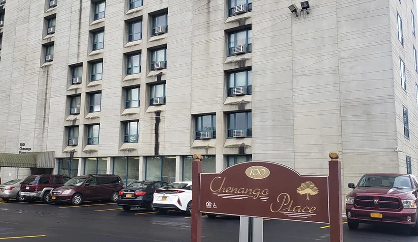 Apartment building with parking lot exterior at 100 Chenango Place in Binghamton Student Accommodation