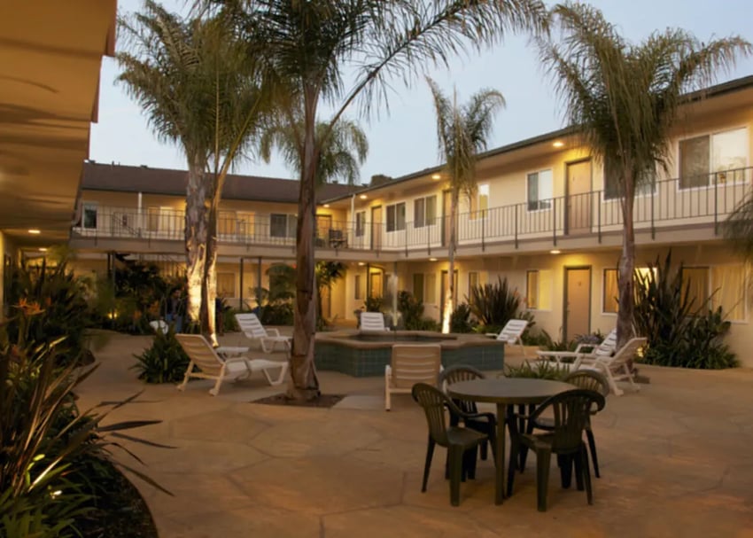 Courtyard with tables chairs fountain exterior at Berkshire Terrace in Goleta Student Accommodation