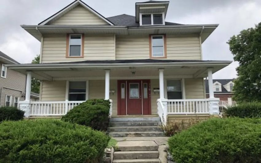 Two story house with red door and porch exterior at Better Ball State Rentals in Muncie Student Accommodation