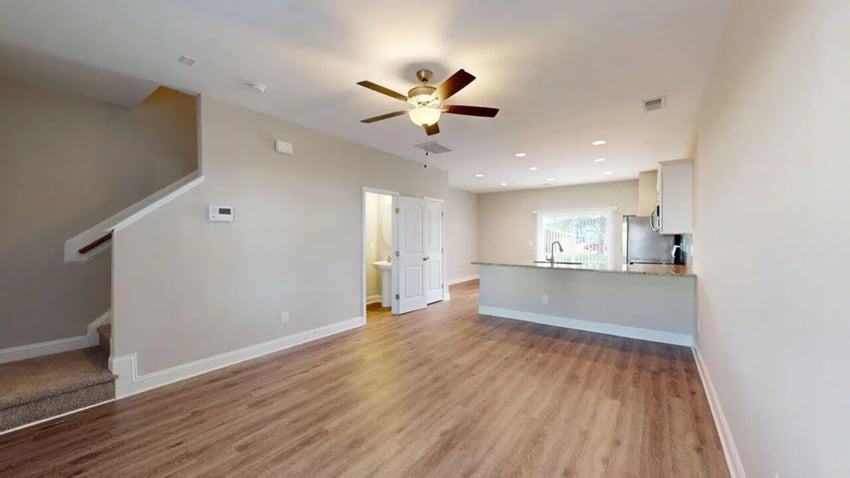 Stairs open door kitchen with sink living room at 11 at Main in Winterville Student Accommodation