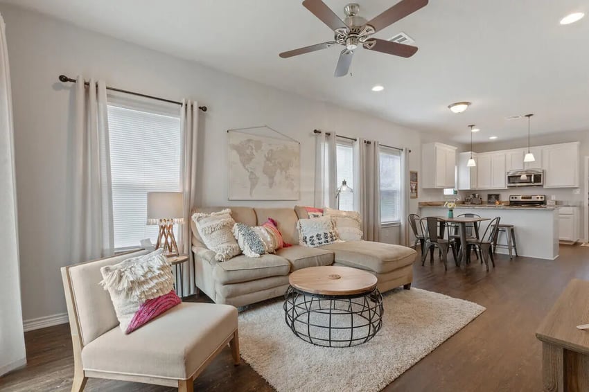 Sofa coffee table chair and kitchen living room at Black Bear Village in Waco Student Accommodation