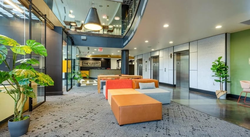 Modern lobby seating with plants elevators and reception area at The Varsity College Park in College Park Student Accommodation