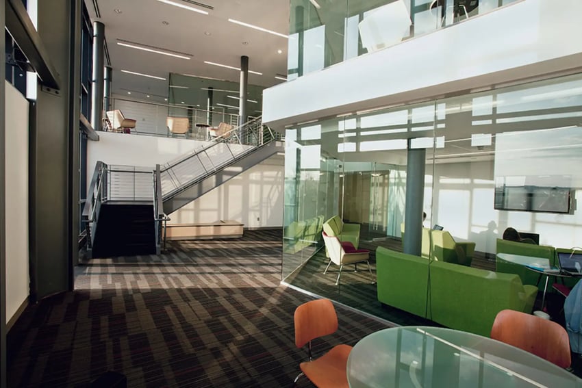 Modern common area with seating stairs and glass living room at Collegetown Terrace Apartments in Ithaca Student Accommodation