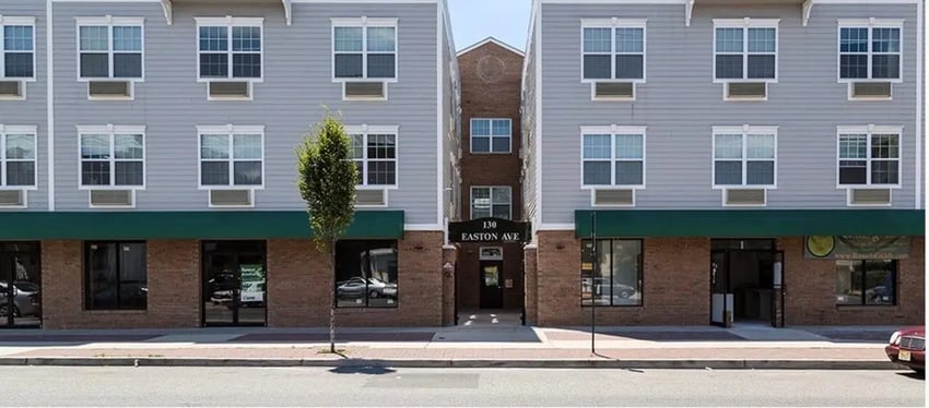 Modern building with windows and green awning exterior at 130 EASTON in New Brunswick Student Accommodation