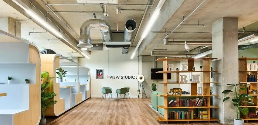 Study booths chairs bookshelf lounge area living room at View Studios in London Student Accommodation