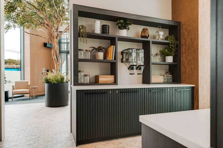 Shelving unit with dispensers and jars common area at Fusion Manchester in Manchester Student Accommodation
