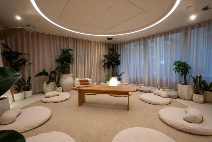 Floor cushions, plants, and wooden table meditation area at Fusion Students Nottingham in Nottingham Student Accommodation