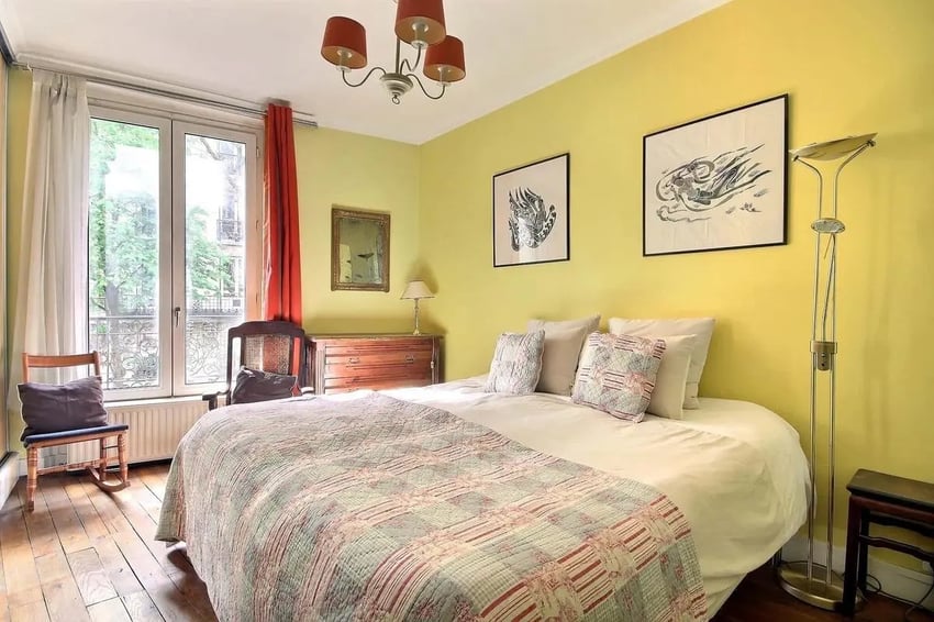 Quilted bed dresser art lamp window bedroom at Apartment in Rue Caulaincourt, 75018 Paris, France in Paris Student Accommodation