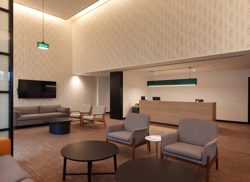 Sofa chairs tables reception desk lounge area at Studeo by UniLodge in Melbourne Student Accommodation