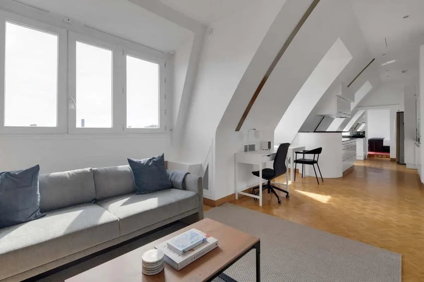 Gray sofa coffee table desk chairs kitchen living room at Rue de Bretagne in Paris Student Accommodation