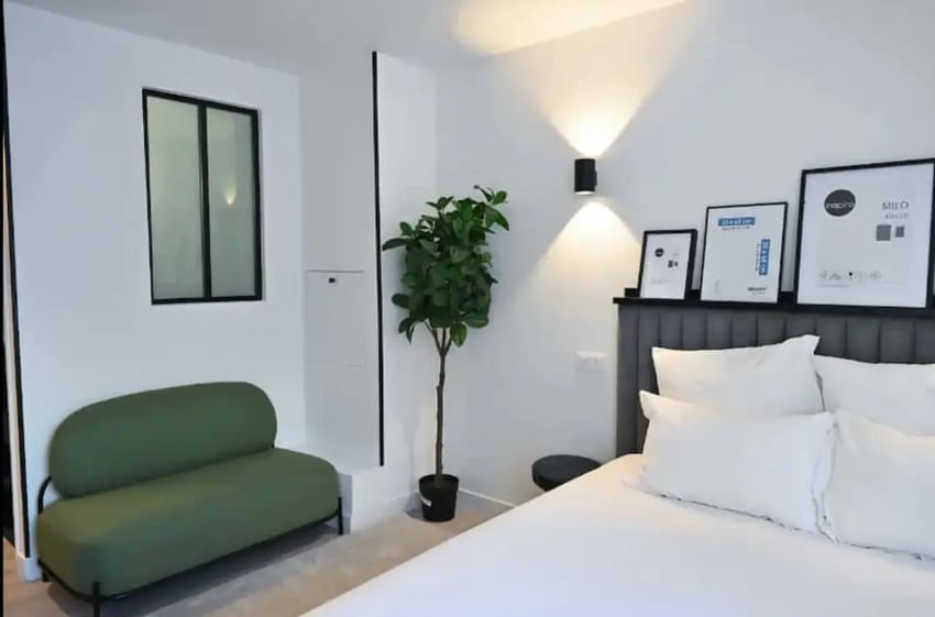 Green sofa framed art plant bedroom at Splendide grand studio parking Canal Saint Martin (Paris) in Paris Student Accommodation