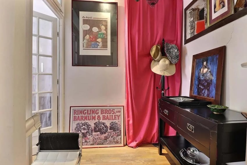 Artwork hats chair and black dresser hallway at Apartment 2 bedrooms 63m² in Paris Student Accommodation